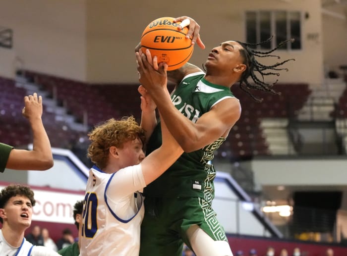 RL Miller grabs a loose ball. Photo: Darren Yamashita.